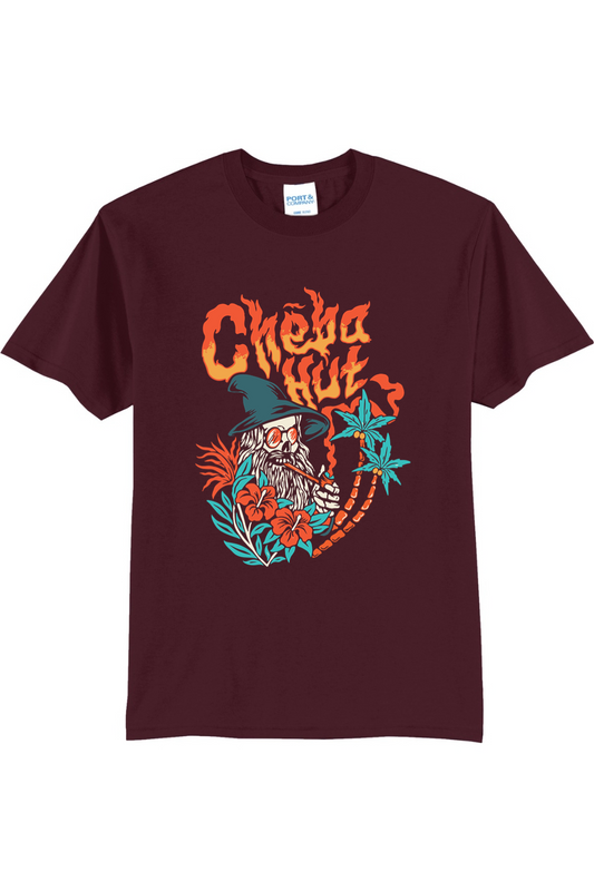 A Maroon short-sleeved t-shirt featuring a colorful graphic on the back depicting a wizard-like figure with a long white beard, a pointed hat, sunglasses, and a pipe, surrounded by flames, hibiscus flowers, and palm trees, with the 'Cheba Hut' logo above.